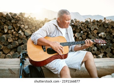 . Mature Man, Relaxing And Playing The Guitar While Sitting Outdoors And Enjoying His Hobby While Getting Fresh Air. Older Man Singing A Song In His Free Time In Retirement With A Musical Instrument