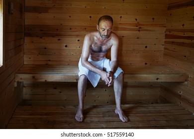 Mature Man Relaxing In Sauna With Head Down