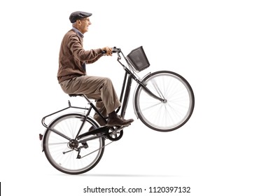 Mature Man Riding A Bicycle And Doing A Wheelie Isolated On White Background