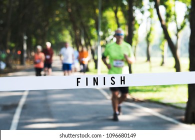 Mature Man Running Towards The Finish Line