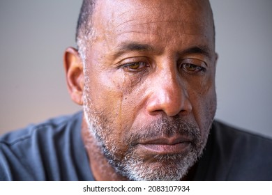 Mature man sad with tears in his eyes.