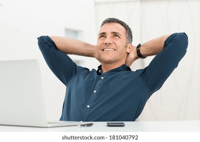 Mature Man Satisfied Sitting In Front Of Laptop Daydreaming - Powered by Shutterstock