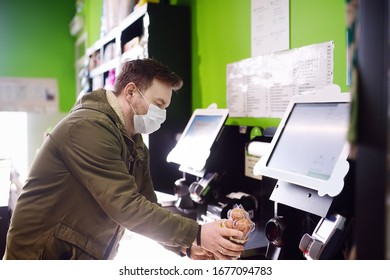 Mature Man Is Scanning Grocery Items With Bar Code Scanner In Supermarket Contactless Method By Checkout Counter. Safety During COVID-19 Outbreak In Public Places. Epidemic Of Virus Covid. Coronavirus