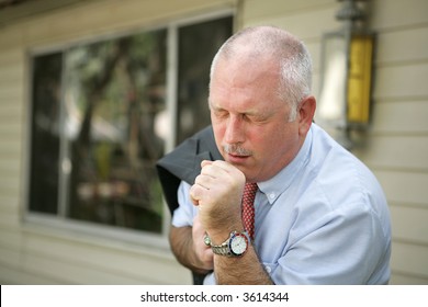 A mature man with a severe cough - probably the flu. - Powered by Shutterstock