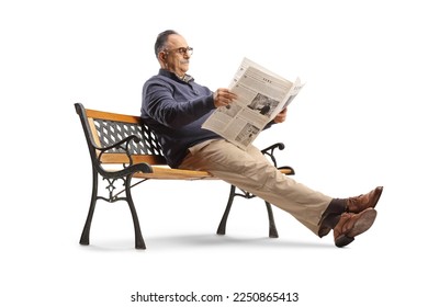 Mature man sitting on bench and reading a newspaper isolated on white background