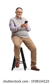 Mature Man Sitting On A Chair And Holding A Mobile Phone Isolated On White Background