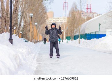 Mature Man Skating On The Ice Track In The Park.