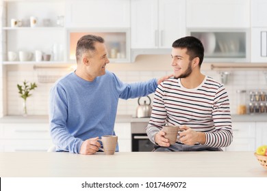 Mature man spending time with his son at home - Powered by Shutterstock