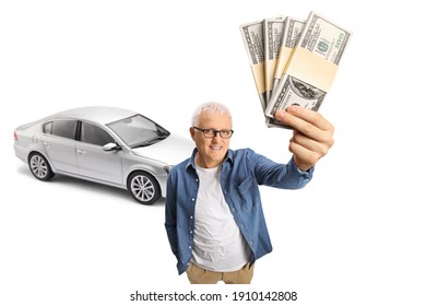 Mature Man Standing In Front Of A Silver Car And Holding Money Isolated On White Background