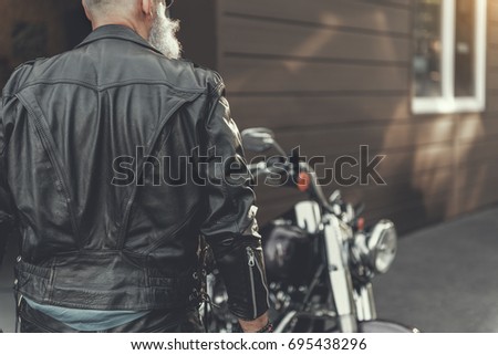 Similar – Senior man repairing damaged motorcycle engine