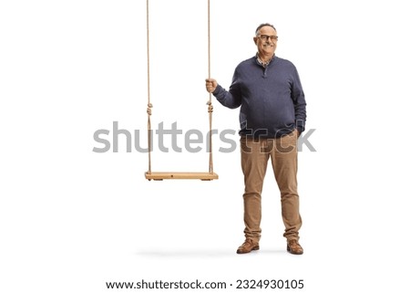 Mature man standing next to a wooden swing isolated on white background
