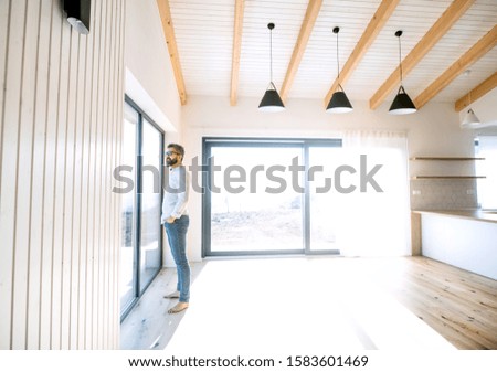 Similar – Man standing barefoot on a wooden walkway