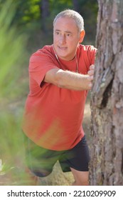 Mature Man Stretching In The Park