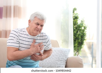 Mature Man Suffering From Chest Pain At Home