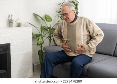 Mature man suffering from pain at home