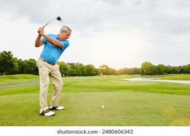 Mature, man and swinging on golf course or nature for recreation sport, practice and training for tournament match. Male golfer, country club and playing with skill for coordination and exercise. - Powered by Shutterstock