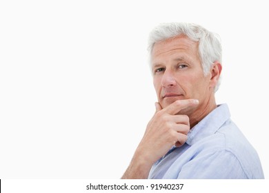 Mature Man Thinking Against A White Background