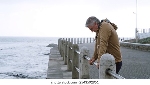 Mature man, thinking and stress by ocean with outdoor, planning or reflection for break on weekend. Male person, mental health and wellness by seaside, beach or water for ideas, memory or mindfulness - Powered by Shutterstock