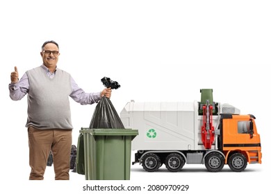 Mature Man Throwing A Plastic Bag In A Bin And Showing Thumbs Up In Front Of A Garbage Truck Isolated On White Background