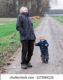 Mature Man With Toddler Looking Up To The Sky – Kempen, Germany