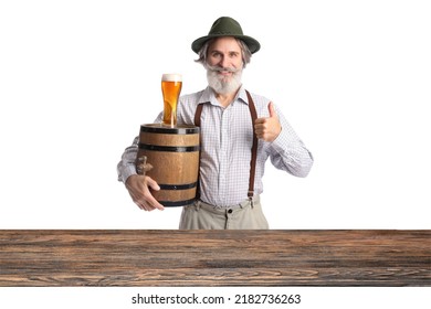 Mature man in traditional German clothe and with beer showing thumb-up at table on white background - Shutterstock ID 2182736263