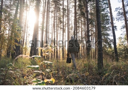 Mature man traveling in wild nature while walking through the path