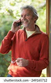 Mature Man Using Cordless Phone At Home