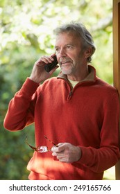 Mature Man Using Cordless Phone At Home