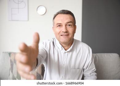 Mature Man Using Video Chat At Home