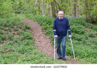 Mature Man Walking With Crutches, Exercise Is An Important Part Of Recovery After Hip And Knee Replacement Surgery