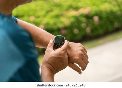 Mature man wearing sportswear using Smart Watch Showing Heart Rate Monitor. Old man with Technology for health and sport mode. Exercise and take statistics to develop your potential - Powered by Shutterstock