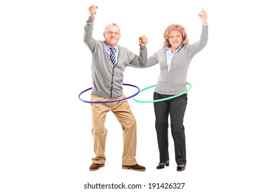 Mature Man And Woman Exercising With Hula Hoop Isolated On White Background
