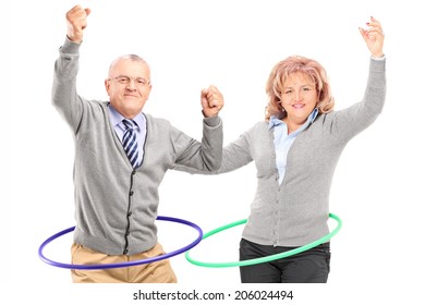 Mature Man And Woman Exercising With Hula Hoop Isolated Against White Background