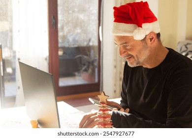 Mature man working at his workplace during Christmas holidays - Powered by Shutterstock