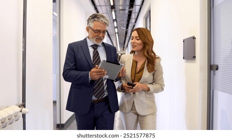 Mature manager checking the work of his young team member