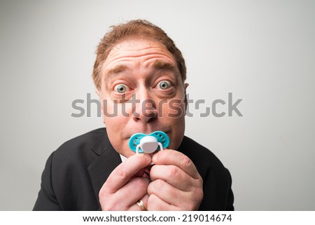 Mature manager with  a pacifier looking at the camera