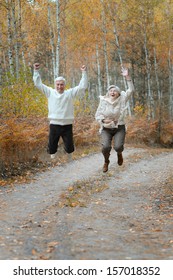 Mature married couple having fun on fresh air in autumn
