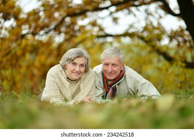Mature married couple having fun on fresh air in autumn