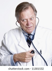 Mature Medical Doctor Listening To His Heart Beat With Stethoscope