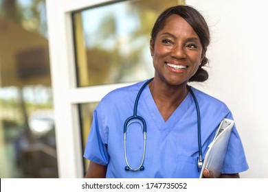 Mature Medical Worker Smiling At Work.