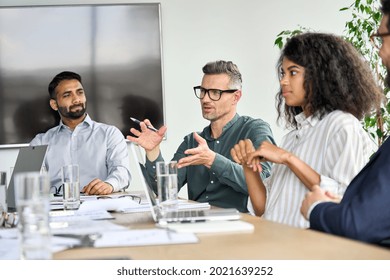 Mature mentor manager speaking at executive team meeting in boardroom. Male leader training executive team at board briefing. Multicultural professional business people discussing strategy in office