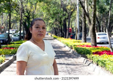 Mature Mexican Woman Looking At Camera, Standing On City Streets. Latina Woman Looking At Camera. Serious Attitude.