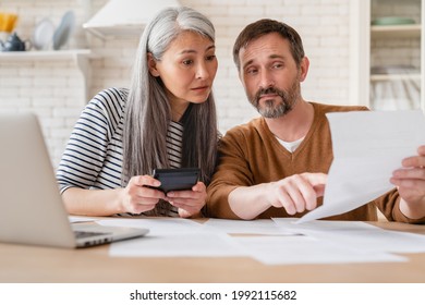 Mature Middle-aged Couple Wife And Husband Family Doing Paperwork, Paying Bills, Pension, Financial Documents Operations Transactions, Divorce Contract, Bankruptcy, Court Case, Health Problems At Home