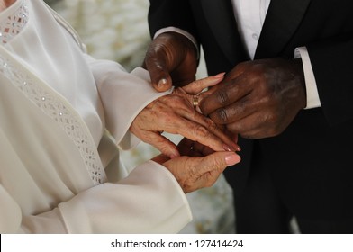 Mature mixed  couple exchanging vows and wedding rings a wedding ceremony - Powered by Shutterstock