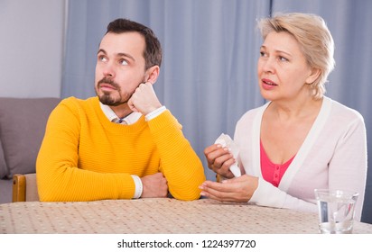 Mature Mother Quarrelling With Her Adult Son At Home