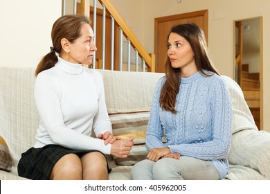 Mature Mother With  Teen Daughter Having Serious Talking In Home 