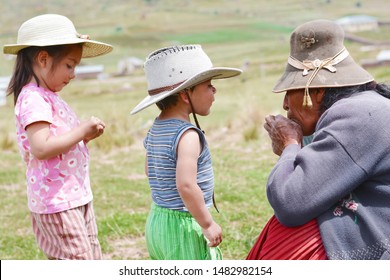 Mature Native American Woman Playing With Children.