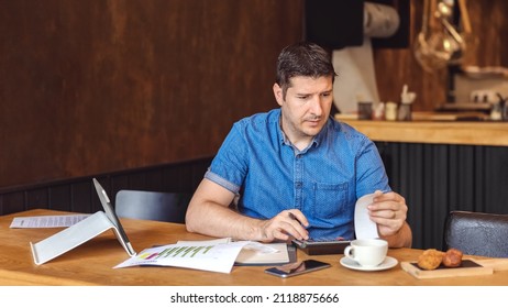 Mature new small business owner calculating online restaurant bill expenses and taxes - Shutterstock ID 2118875666