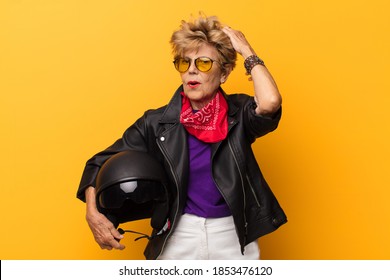 Mature Old Beautiful Woman Feeling Puzzled And Confused, Scratching Head And Looking To The Side. Motorbike Concept