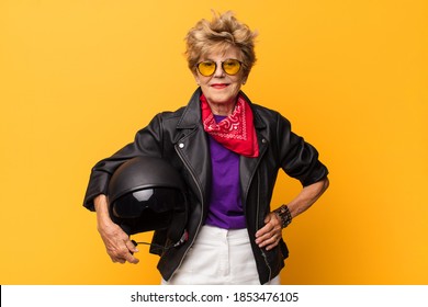 Mature Old Beautiful Woman Smiling Happily With A Hand On Hip And Confident, Positive, Proud And Friendly Attitude. Motorbike Concept